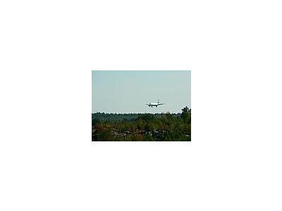Photo Small Airplane Landing Over Woods Vehicle