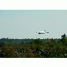 Photo Airplane Landing Over Woods Vehicle