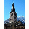 Photo Small Church Tower With Mountain In Background Building title=